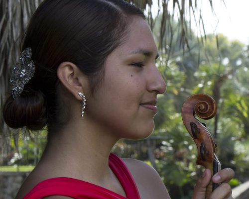 Woman wearing pink dress in side view.